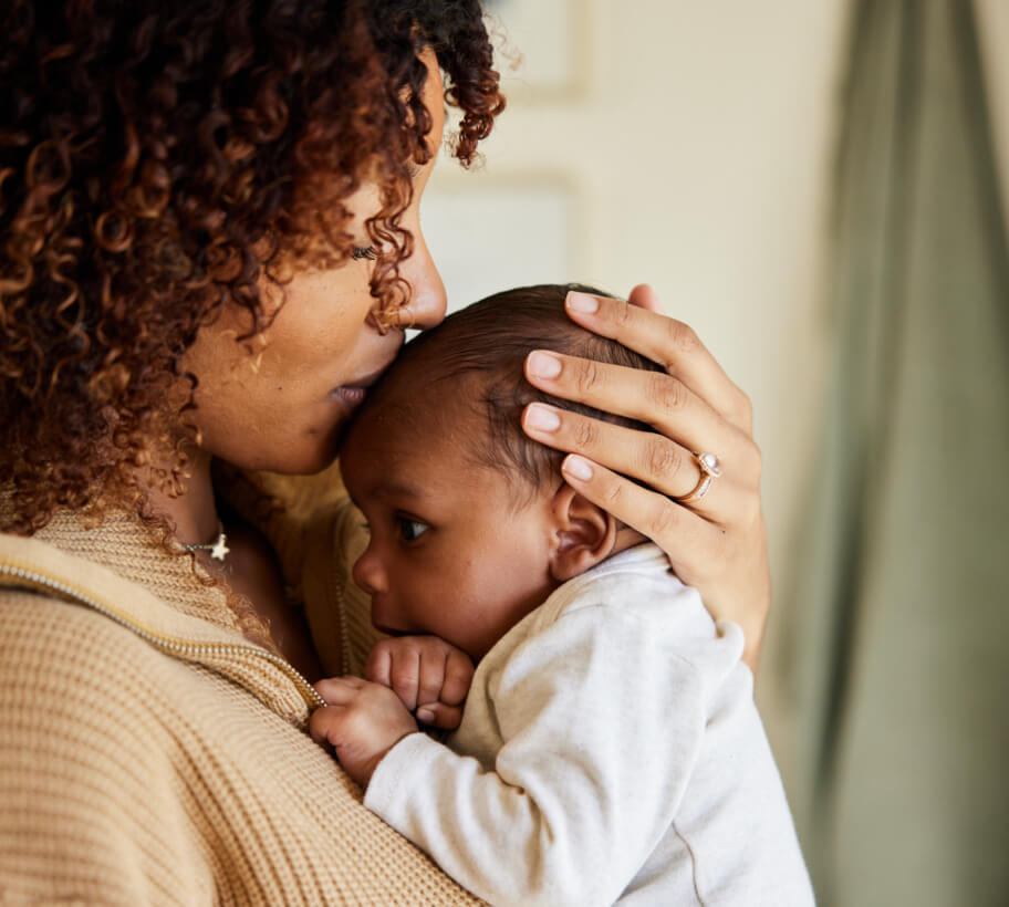 mother kissing baby